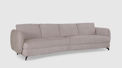 A contemporary sofa with plush, off-white upholstery, a unique curved back, voluptuous arms and slim, black, steel, legs. 