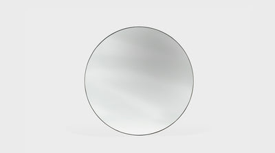 A classic round mirror with a timber frame.