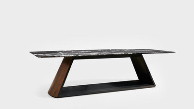 An art deco dining table with a black marble top and a geometric, diagonal, oak ash and black base.