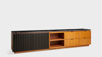A modern, contemporary TV unit with a walnut timber frame, black, ribbed, timber doors and a black, stone, top. It has cupboards, shelves and drawers.