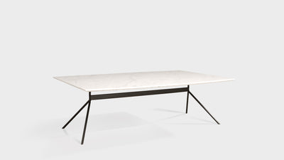 A contemporary coffee table that has a rectangular, marble top and slim, black, steel legs.