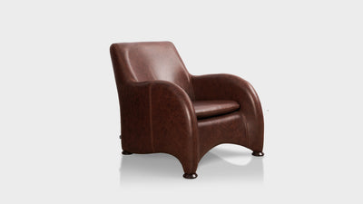An occasional chair that has soft sweeping lines and curved arms. It is fully upholstered in brown leather and has a pitched seat.