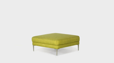 A modern, square, lime green upholstered ottoman with silver steel legs.