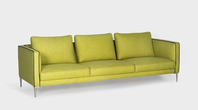 A lime green modern sofa with slim arms, sleek steel legs and black piping.