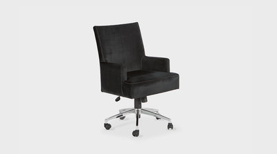 A desk chair that has a high back and wide seat. It features luxury, tailored, black, upholstery with white stitching and a chrome base with wheels that is adjustable.