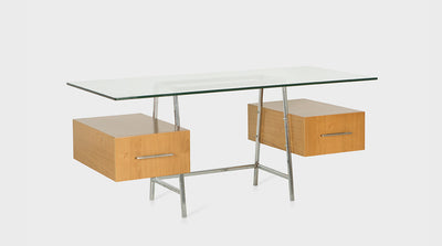 A contemporary desk with a glass top, chrome legs and two oak drawers with long, slim, steel handles.