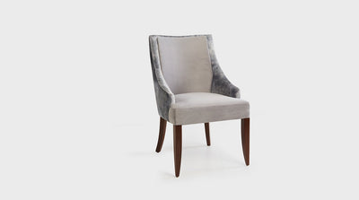A classic dining chair with a curved frame and medium mahogany legs. It has tailored, off-white upholstery on the seat and panel and detail silver grey upholstery on the back.