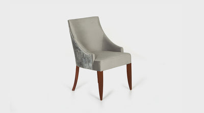 A classic dining chair with a curved frame and natural mahogany legs. It has a white cross-stitching detail that lines the tailored, grey, upholstery on the seat and a silver grey upholstery on the back.