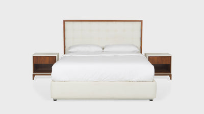 A bed set that has a cream upholstered headboard, with a block stitch detail, and a timber frame. It also has a cream coloured upholstered bed base.
