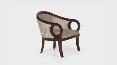 An art deco inspired occasional chair made with papyrus coloured fabric and a medium mahogany timber frame. This chair has a rounded back, circular arms and curved legs.