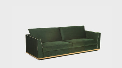 A modern, emerald green, sofa with a natural mahogany trim and piping detail on the arms.