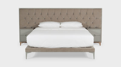 This bed puts a contemporary twist on a classic bed. It has a diamond button headboard which is upholstered in a beige, velvet, fabric and has a contrasting timber frame. The bed base is upholstered in a velvet, beige, fabric and has timber legs.