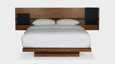 This bed is a contemporary design with an industrial aesthetic. It has an oak timber bed base and and an oak timber headboard with built in, black, powder coated, steel pedestals and trim.