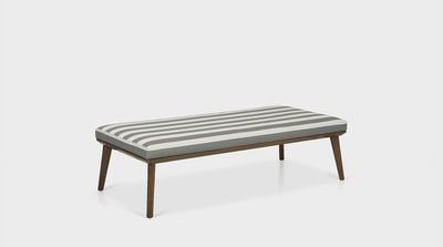 Wide ottoman with striped upholstered top combined with diagonally tapered timber legs.