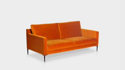 A bold, orange, contemporary sofa with a retro twist. Fully upholstered with slim arms and black steel legs. 