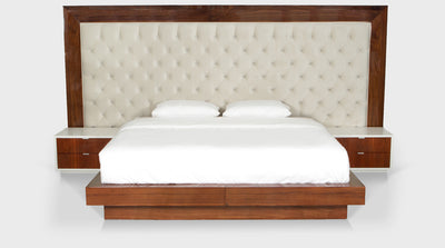 A large, diamond button headboard with walnut frame and walnut bed base, front view.