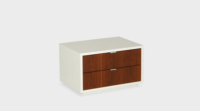 A modern pedestal with a white, painted timber frame and two walnut drawers with slim, silver handles.