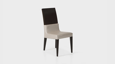 A dining chair which features a high backrest made of dark mahogany timber and a pearl coloured, faux leather, upholstered seat.
