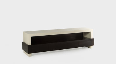 A modern TV unit with a papyrus coloured frame and dark mahogany drawers that have a wraparound detail.