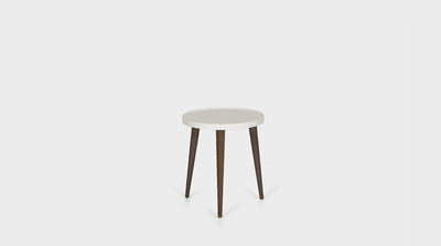 A contemporary, timber, side table with three, tapered, diagonal legs and a round top. 
