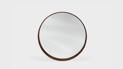 A round mirror with a Scandi design, this mirror has a natural mahogany frame.