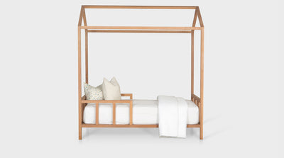 A contemporary children's bed with a house design and an oak frame, side frame.