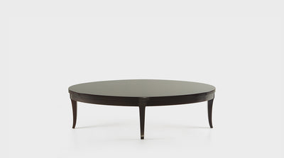 A classic, mahogany coffee table with an oval top and curved legs.