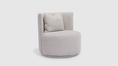 A round occasional chair that swivels 360 degrees on its timber base. It is fully upholstered in cream boucle.
