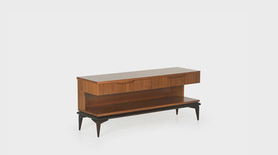 A mid-century inspired TV unit  with a walnut top and mahogany base that has tapered legs. It has two drawers with groove handle details and shelving space.