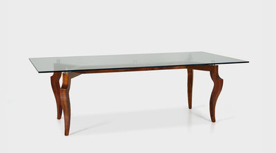 A classic dining table with elegant, curved, walnut legs, silver accents and a clear, glass, rectangular top.
