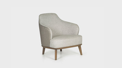 A mid-century, Italian inspired occasional chair. It has winged arms upholstered in linen fabric and an oak base with tapered, diagonal legs. It features a rounded back and a pitched seat.