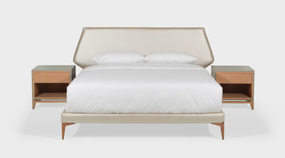 A bed with a modern design featuring a faux leather, pearl coloured,  upholstered headboard and bed base.
